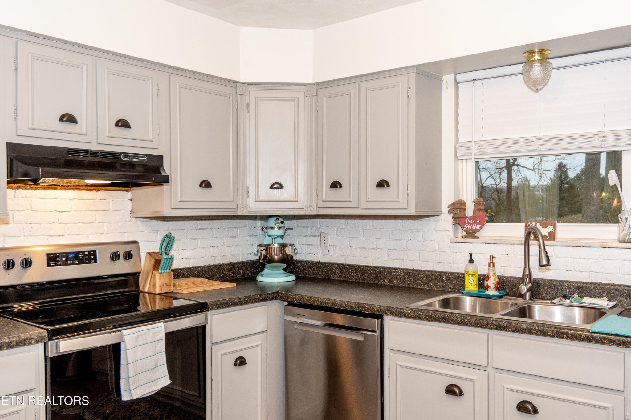 109 Ivy Lane Clinton, TN 37716 - Photo 10 of 36 a kitchen with stainless steel appliances granite countertop a sink a stove and a white wooden cabinets