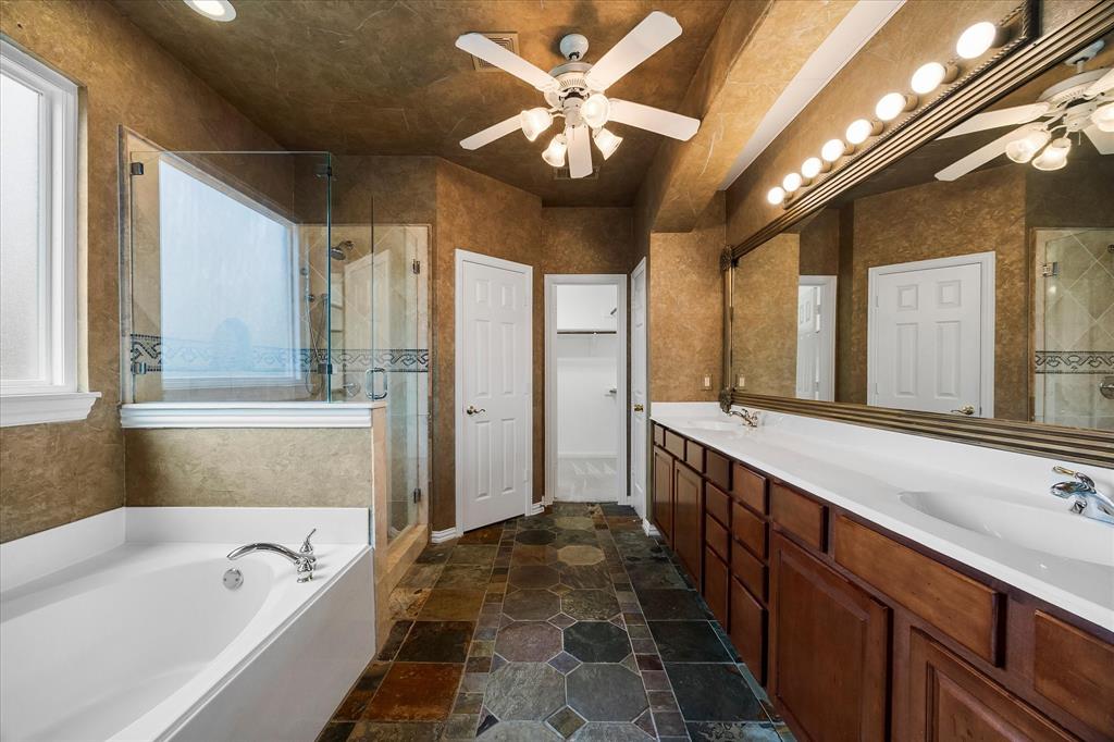 645 Channel Ridge Drive Rockwall, TX 75087 - Photo 18 of 40 The well-appointed primary bath includes dual sinks, soaking tub, separate shower, linen and walk-in closets.