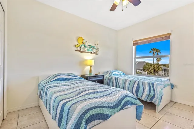 a bedroom with two beds and a chandelier