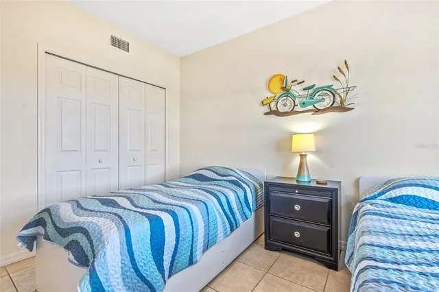 a bedroom with a bed and lamp on table
