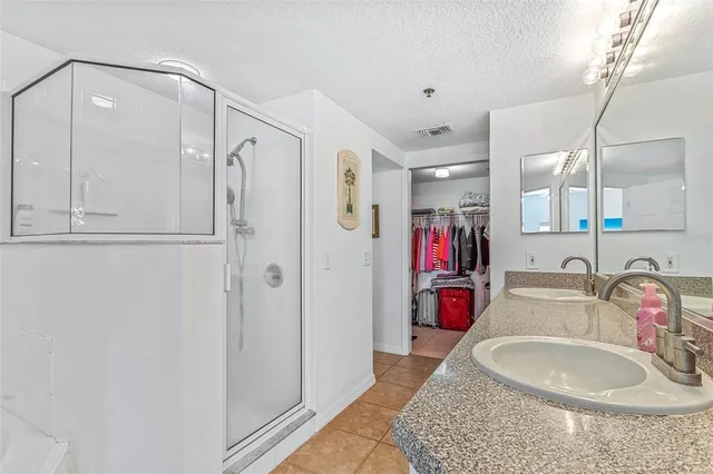 a bathroom with a tub sink mirror and vanity