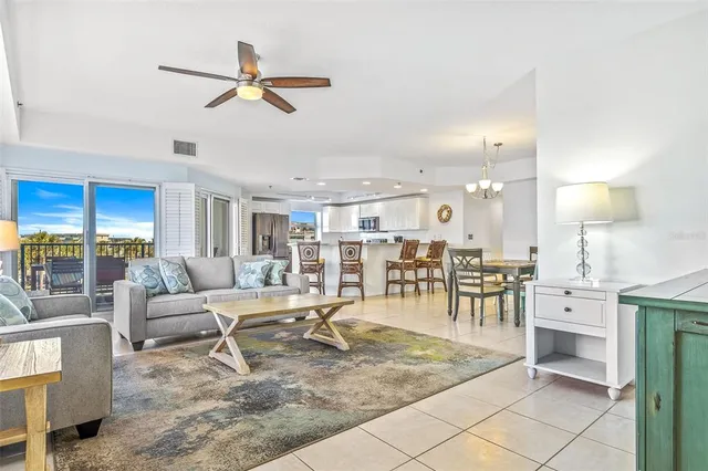 a living room with lots of furniture and view of kitchen