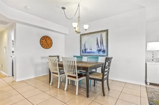 a view of a dining room with furniture and a chandelier
