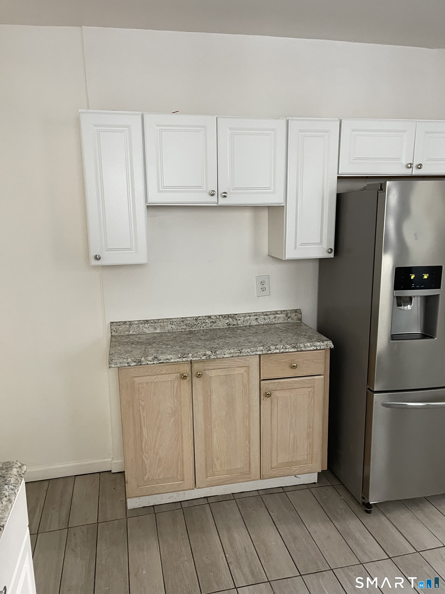 191 Parrott Avenue, Unit 1 Bridgeport, CT 06606 - Photo 3 of 9 a kitchen with stainless steel appliances granite countertop a refrigerator and a stove