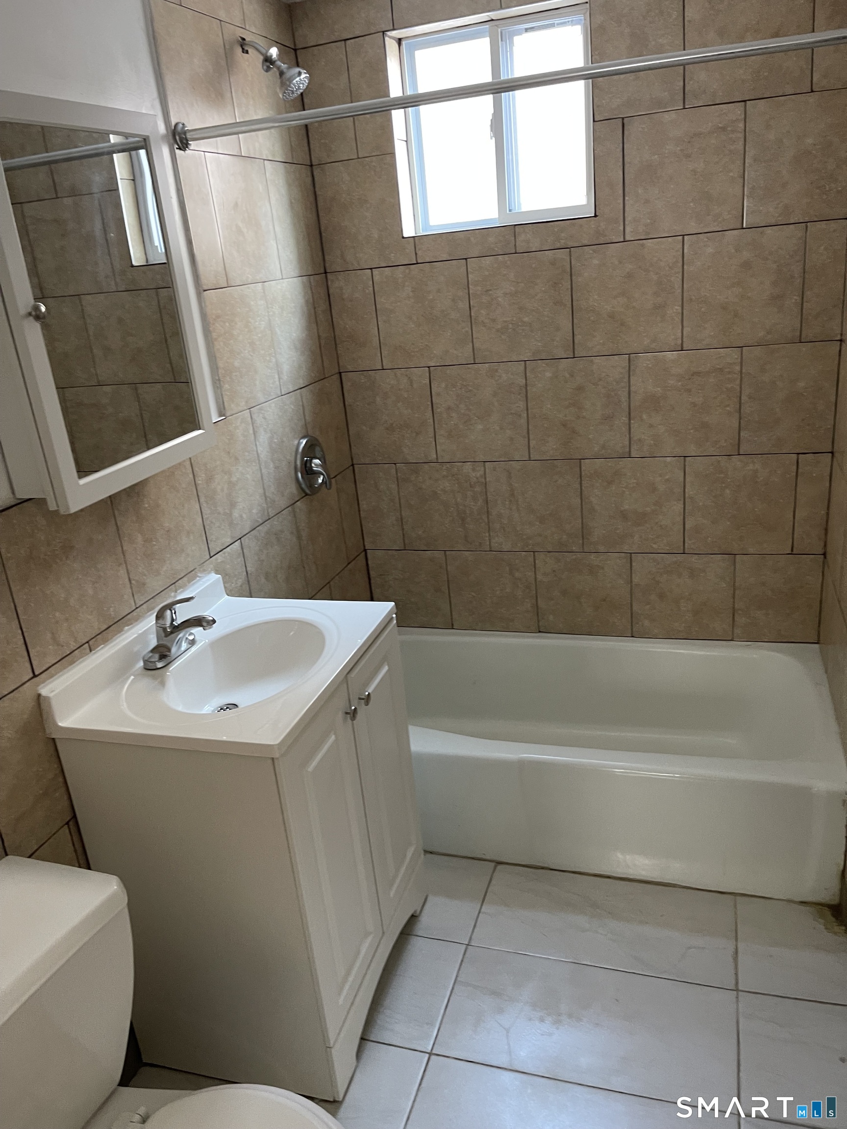 191 Parrott Avenue, Unit 1 Bridgeport, CT 06606 - Photo 7 of 9 a bathroom with a sink a toilet and shower