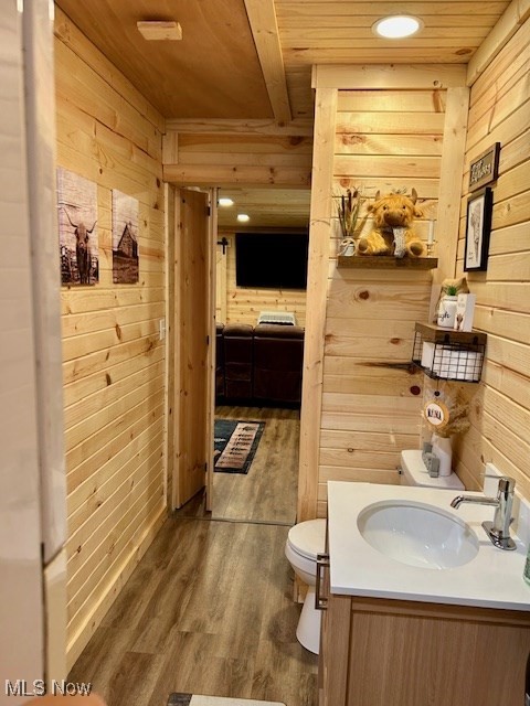 2445 McCord Hill Road Wellsburg, WV 26070 - Photo 10 of 37 Half bathroom with wood walls, dark wood-type flooring, vanity, recessed lighting, and wooden ceiling
