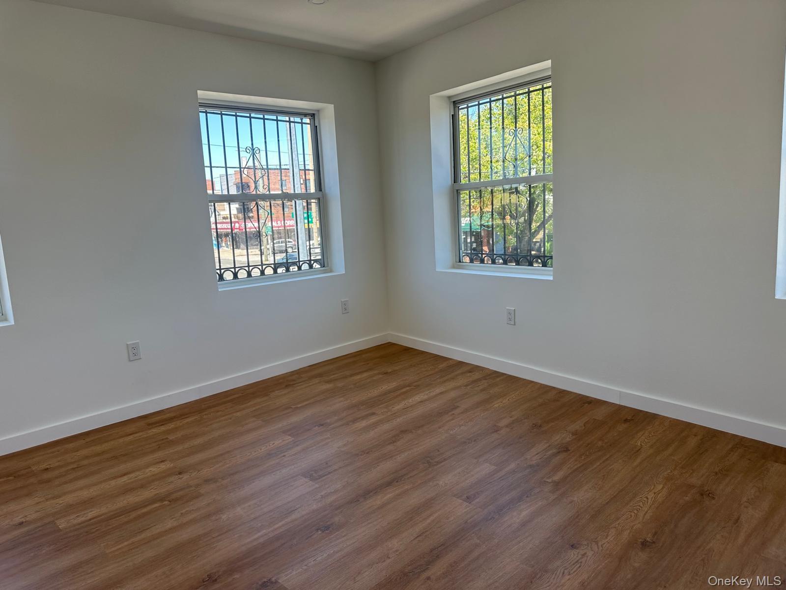 54-01 108th Street, Unit 2F Queens, NY 11368 - Photo 4 of 5 a view of an empty room with wooden floor and a window