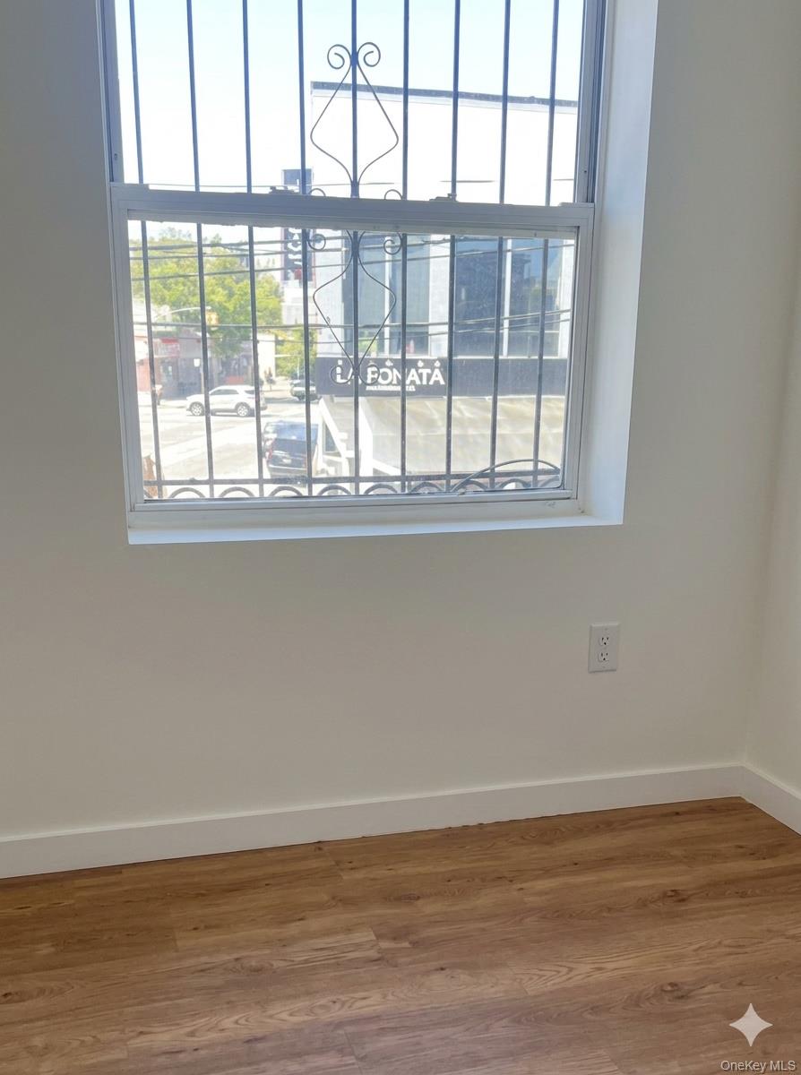54-01 108th Street, Unit 2F Queens, NY 11368 - Photo 5 of 5 a view of wooden floor and a window