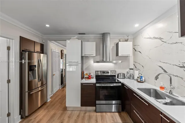 a kitchen with a refrigerator and a sink