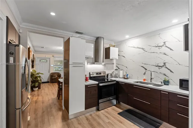 a kitchen with cabinets a sink and appliances