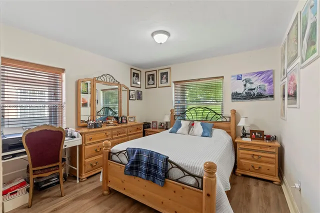 a bedroom with furniture and a window