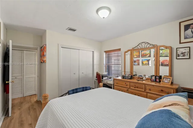 a bedroom with a bed and a large mirror