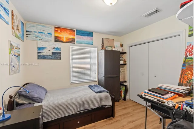 a bedroom with bed and a window