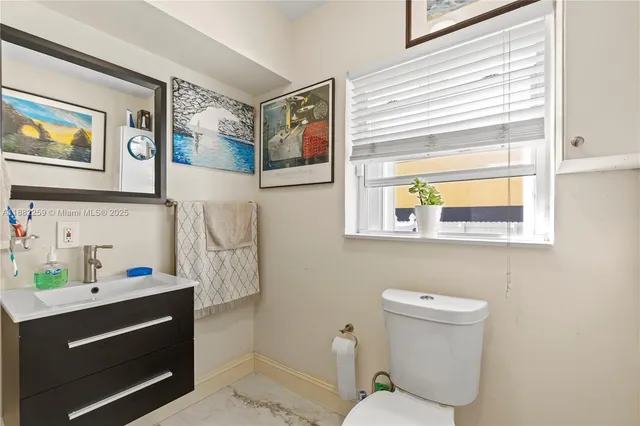 a bathroom with a toilet sink and mirror