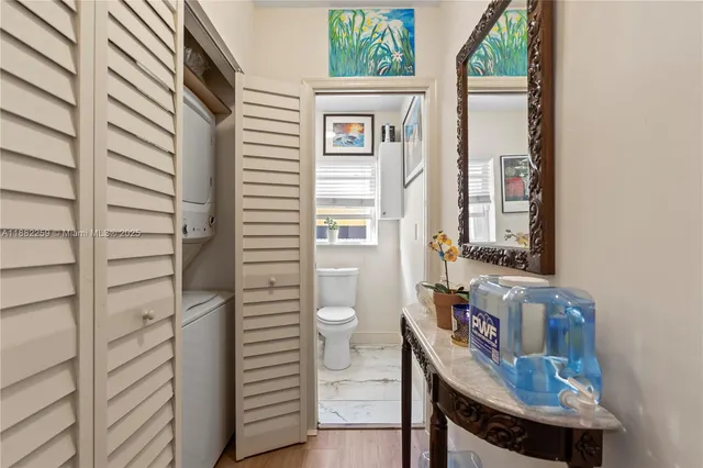 a bathroom with a toilet a sink and mirror