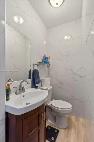 a bathroom with a sink toilet and a mirror