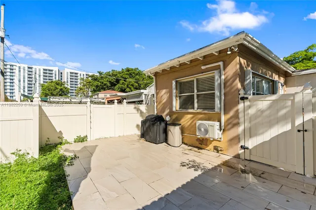 a view of a house with backyard and sitting area