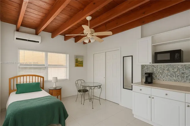 a bedroom with furniture and a window