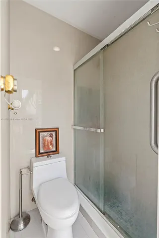 a bathroom with a toilet and a shower