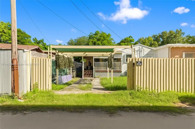 an aerial view of a house with a yard and potted plants