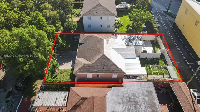 an aerial view of a house with a garden and parking space