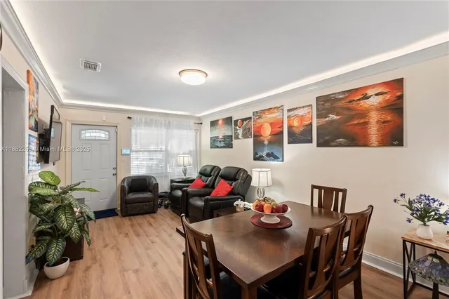 a view of a dining room with furniture window and wooden floor