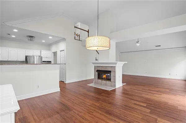a view of a kitchen with a sink a fireplace and wooden floor