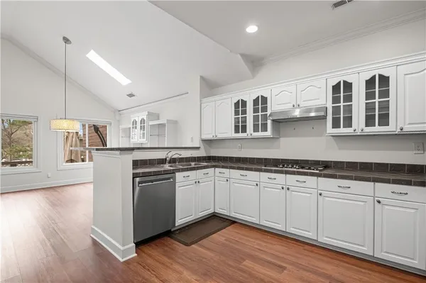 a kitchen with stainless steel appliances granite countertop a stove and a sink