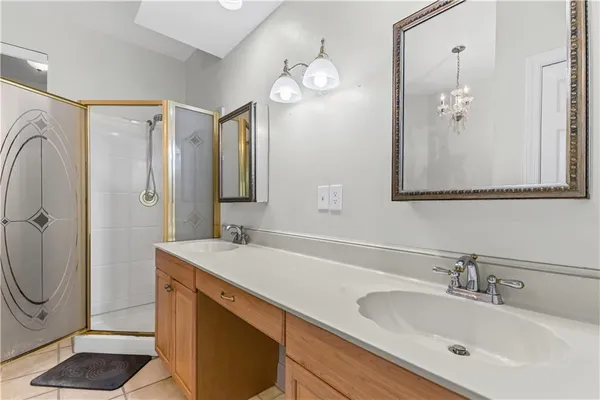 a bathroom with a sink a granite counter and a mirror