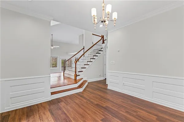 a view of entryway and hall with wooden floor