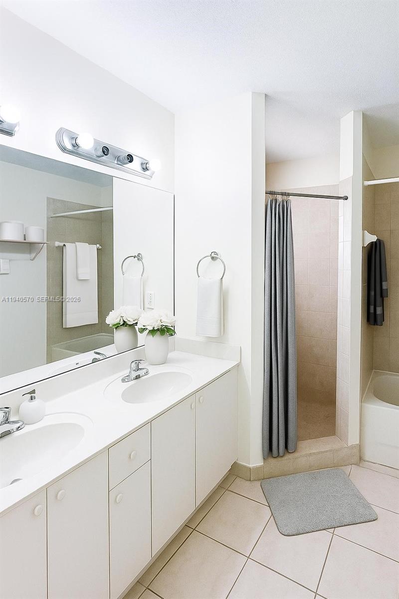 14116 Southwest 260th Street, Unit 105 Homestead, FL 33032 - Photo 16 of 30 a bathroom with a double vanity sink and mirror