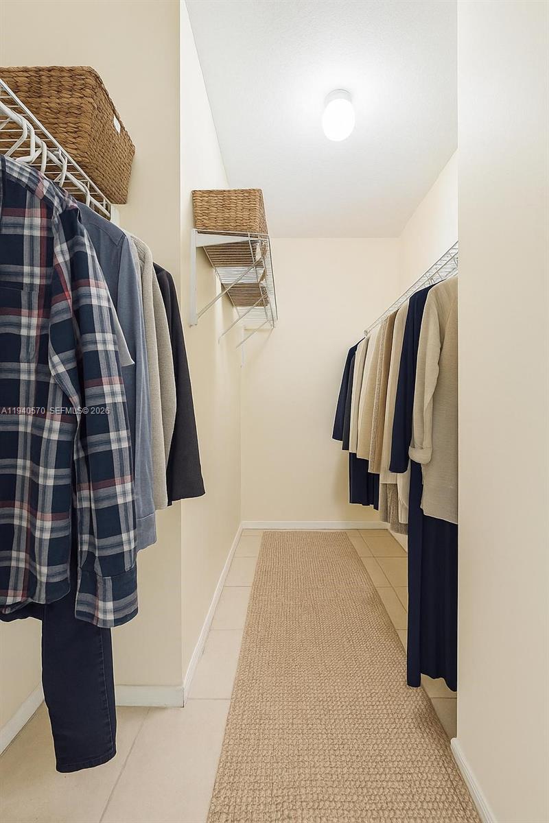 14116 Southwest 260th Street, Unit 105 Homestead, FL 33032 - Photo 17 of 30 a view of walk in closet with clothes and shoes