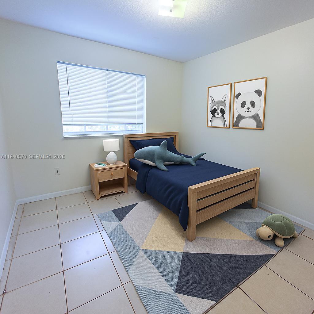 14116 Southwest 260th Street, Unit 105 Homestead, FL 33032 - Photo 19 of 30 a bedroom with a bed and a window