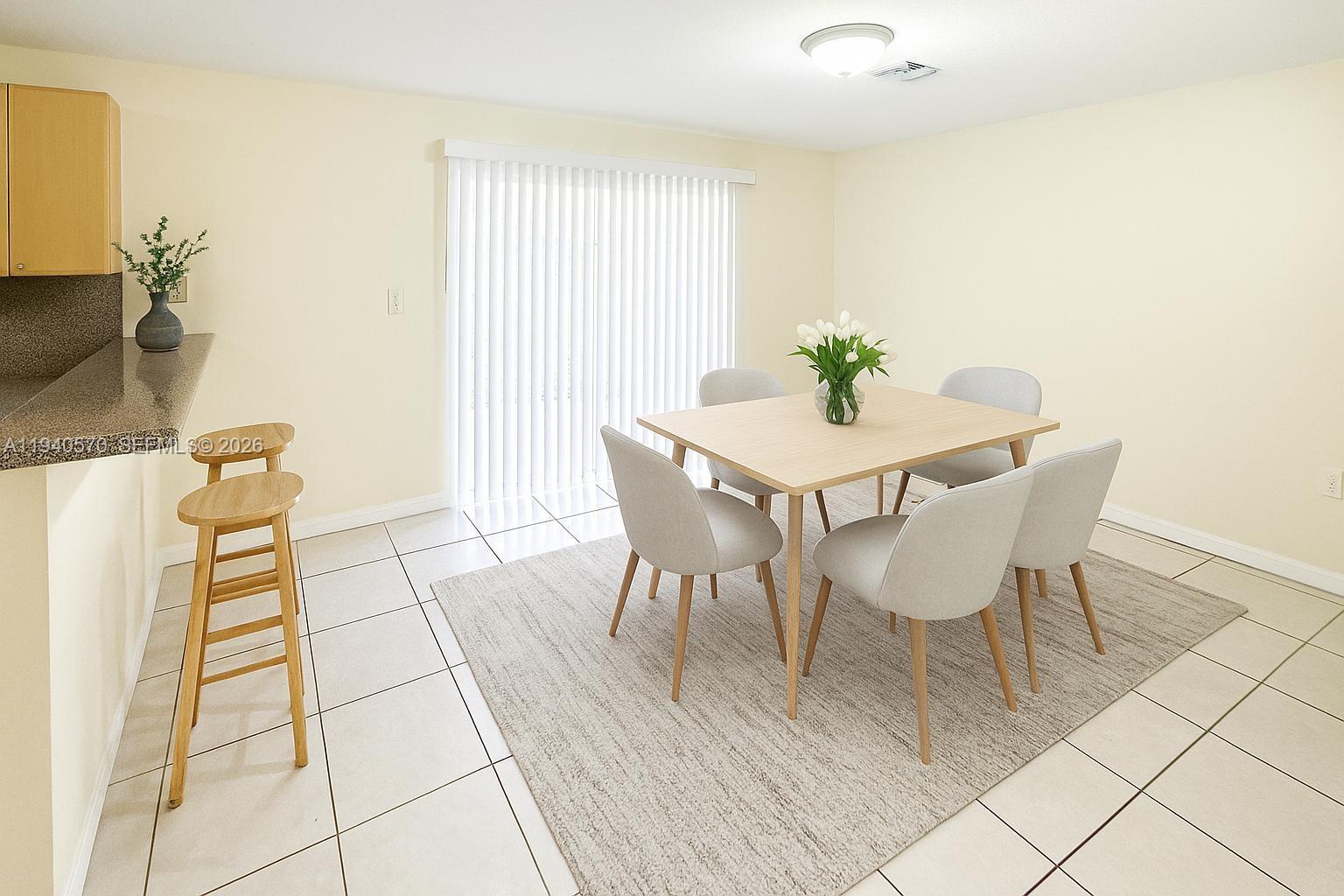14116 Southwest 260th Street, Unit 105 Homestead, FL 33032 - Photo 10 of 30 a view of a dining room with furniture and a potted plant