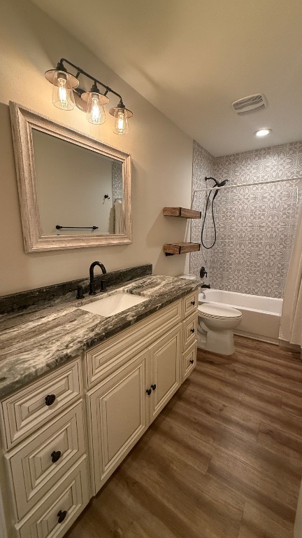 12987 Farm To Market Road 2769 Austin, TX 78726 - Photo 14 of 24 Full bath with vanity, dark wood finished floors, and shower / bath combo with shower curtain