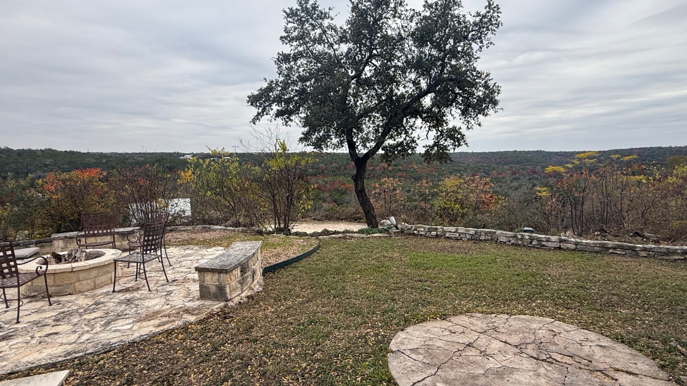 12987 Farm To Market Road 2769 Austin, TX 78726 - Photo 19 of 24 View of grassy yard featuring a fire pit and a patio area