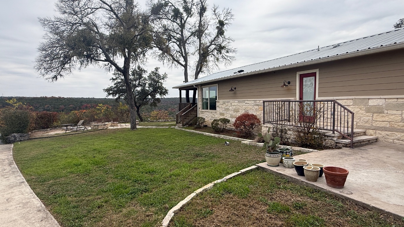 12987 Farm To Market Road 2769 Austin, TX 78726 - Photo 23 of 24 View of green lawn featuring a patio