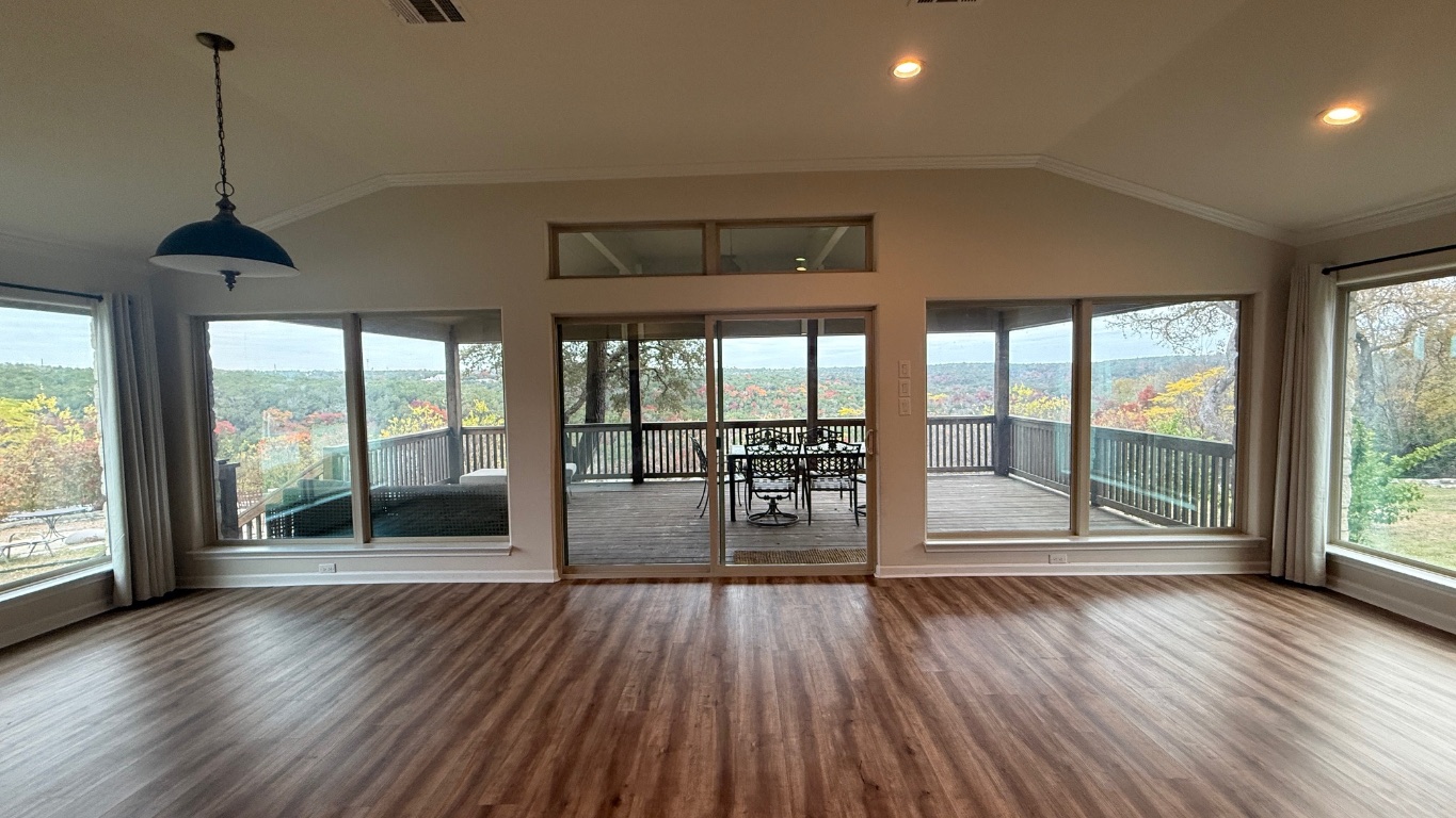 12987 Farm To Market Road 2769 Austin, TX 78726 - Photo 4 of 24 Unfurnished sunroom with vaulted ceiling, ornamental molding, healthy amount of natural light, and wood finished floors
