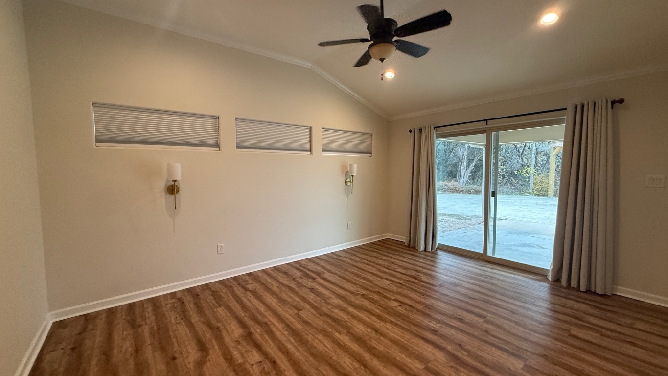 12987 Farm To Market Road 2769 Austin, TX 78726 - Photo 7 of 24 Unfurnished room featuring vaulted ceiling, crown molding, ceiling fan, wood finished floors, and recessed lighting