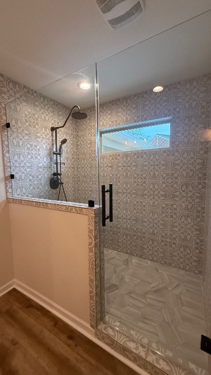 12987 Farm To Market Road 2769 Austin, TX 78726 - Photo 9 of 24 Full bath featuring a stall shower, dark wood-style floors, and wallpapered walls