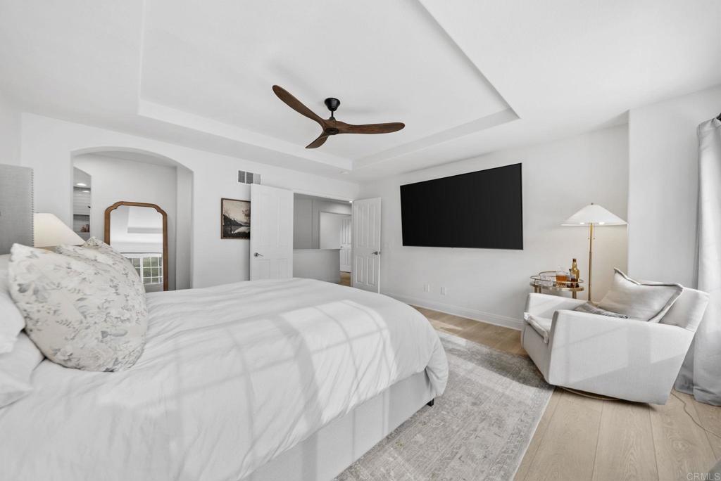 31401 Chemin Chevalier Temecula, CA 92591 - Photo 17 of 74 a spacious bedroom with a bed and a flat screen television