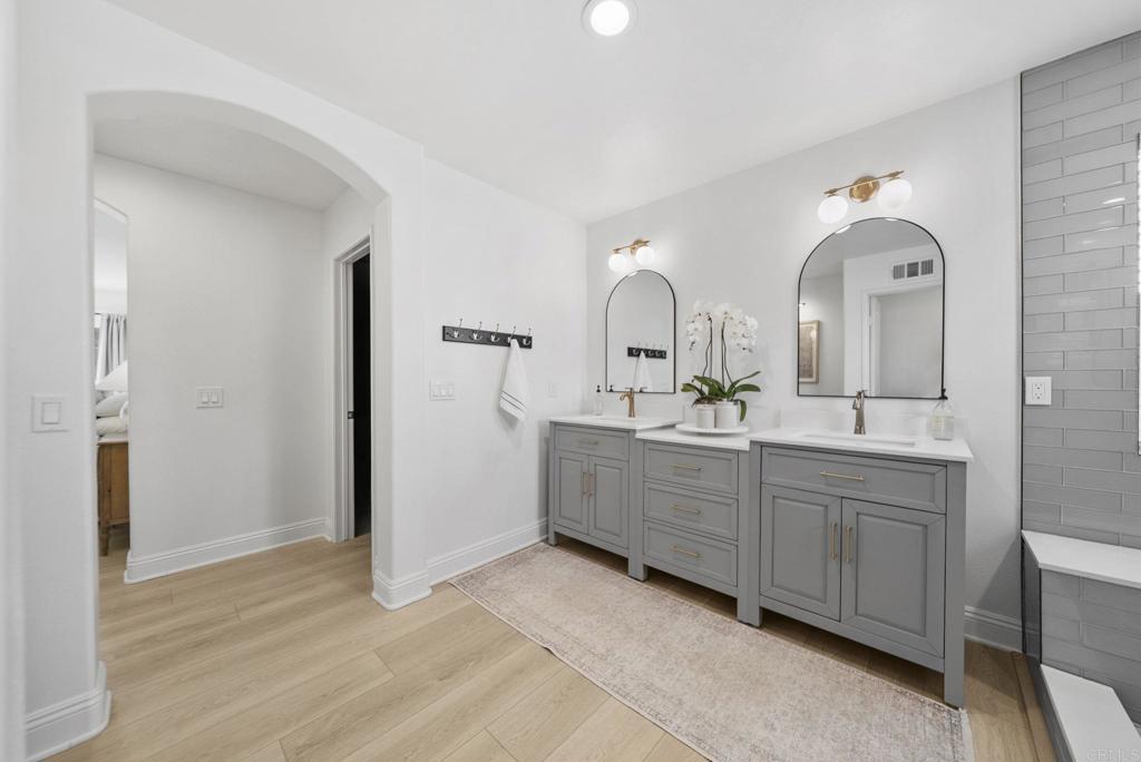 31401 Chemin Chevalier Temecula, CA 92591 - Photo 19 of 74 a spacious bathroom with a double vanity sink and a mirror