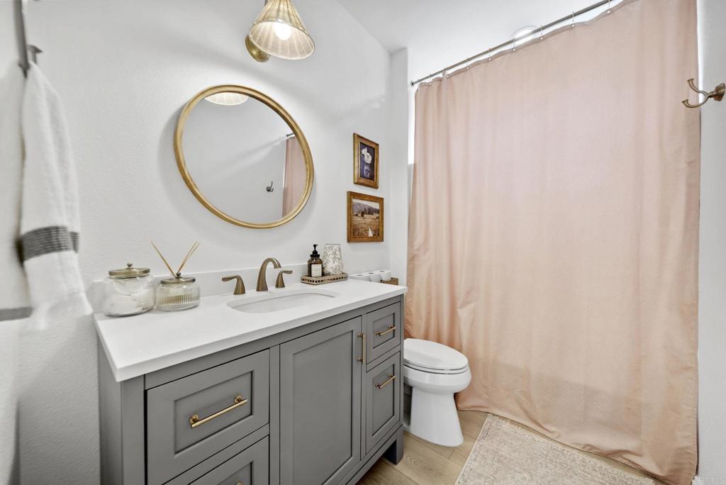 31401 Chemin Chevalier Temecula, CA 92591 - Photo 34 of 74 a bathroom with a granite countertop sink a toilet and a mirror