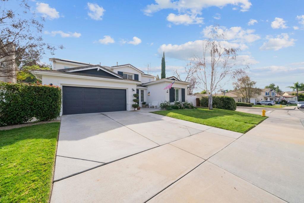 31401 Chemin Chevalier Temecula, CA 92591 - Photo 65 of 74 a front view of a house with a yard and garage