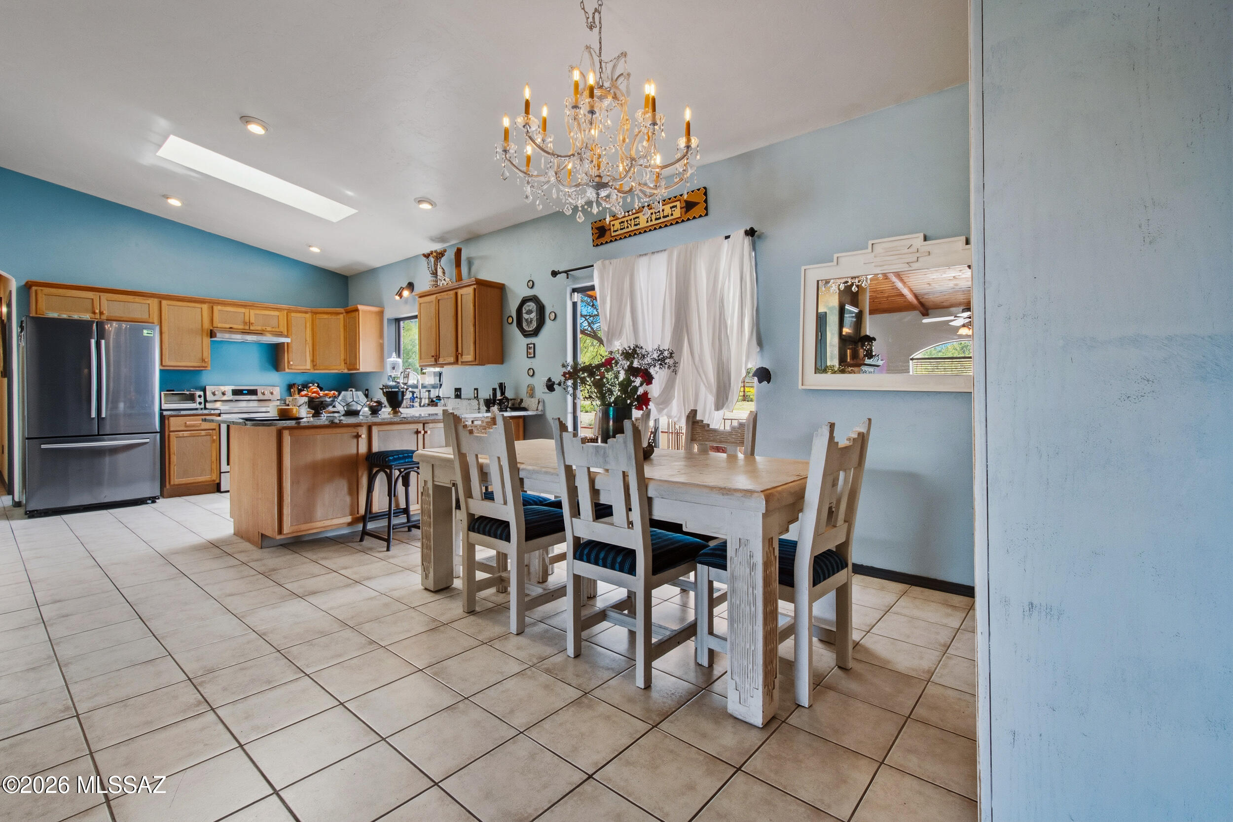 4155 West Coyote Ridge Trail Tucson, AZ 85746 - Photo 20 of 39 a dining room filled chandelier and kitchen view