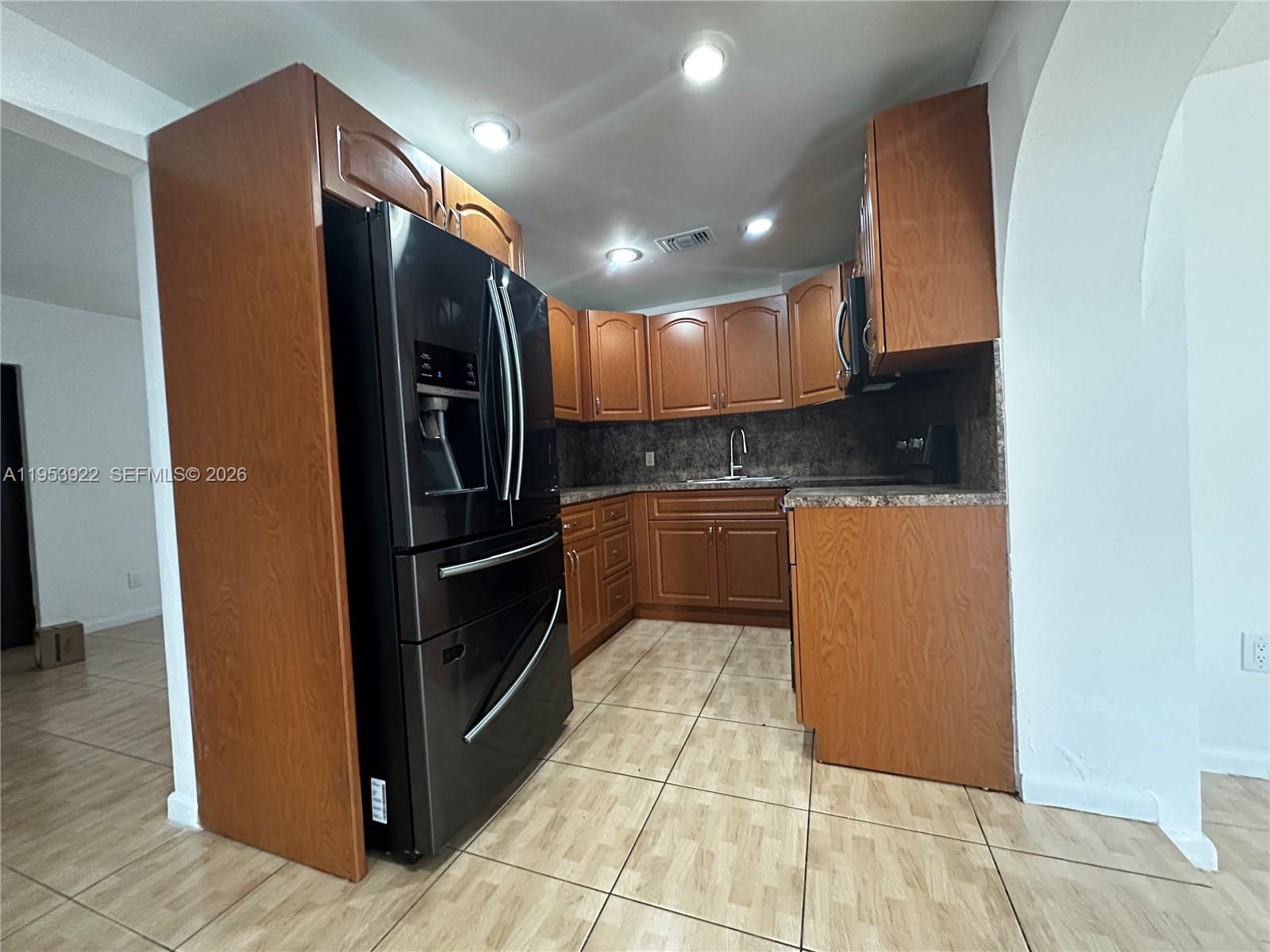 350 West 34th Street Hialeah, FL 33012 - Photo 6 of 22 a kitchen with stainless steel appliances granite countertop a refrigerator and a sink