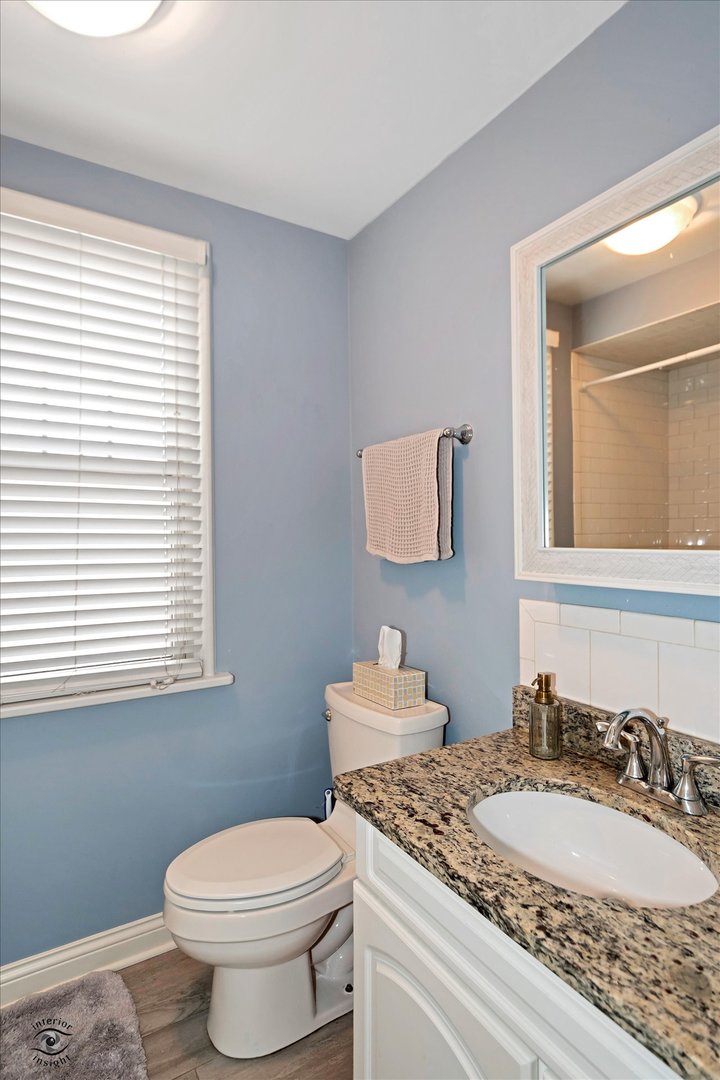 10025 South Hamilton Avenue Chicago, IL 60643 - Photo 27 of 51 a bathroom with a granite countertop toilet a sink and a mirror