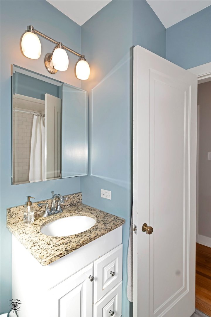 10025 South Hamilton Avenue Chicago, IL 60643 - Photo 33 of 51 a bathroom with a granite countertop sink and a mirror