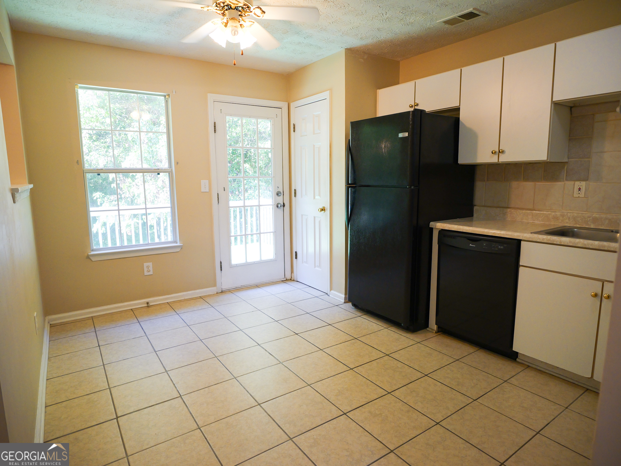 11036 Pebble Ridge Drive Hampton, GA 30228 - Photo 12 of 35 a kitchen with a refrigerator a stove a microwave and cabinets