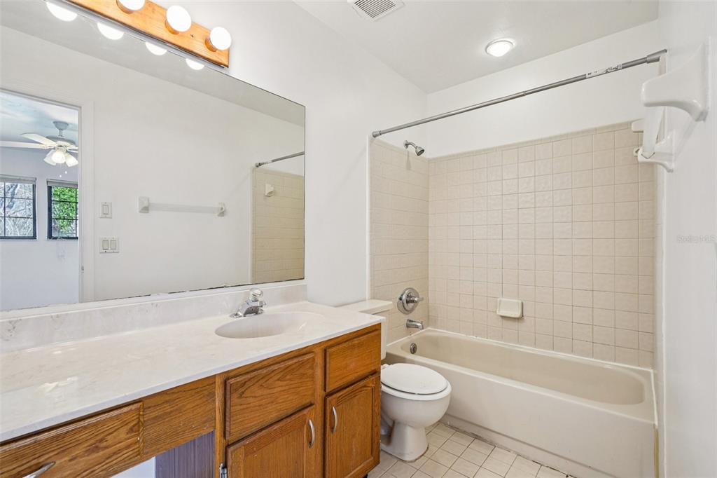 5606 Southwest 8th Place Gainesville, FL 32607 - Photo 19 of 28 a bathroom with a sink a toilet and shower
